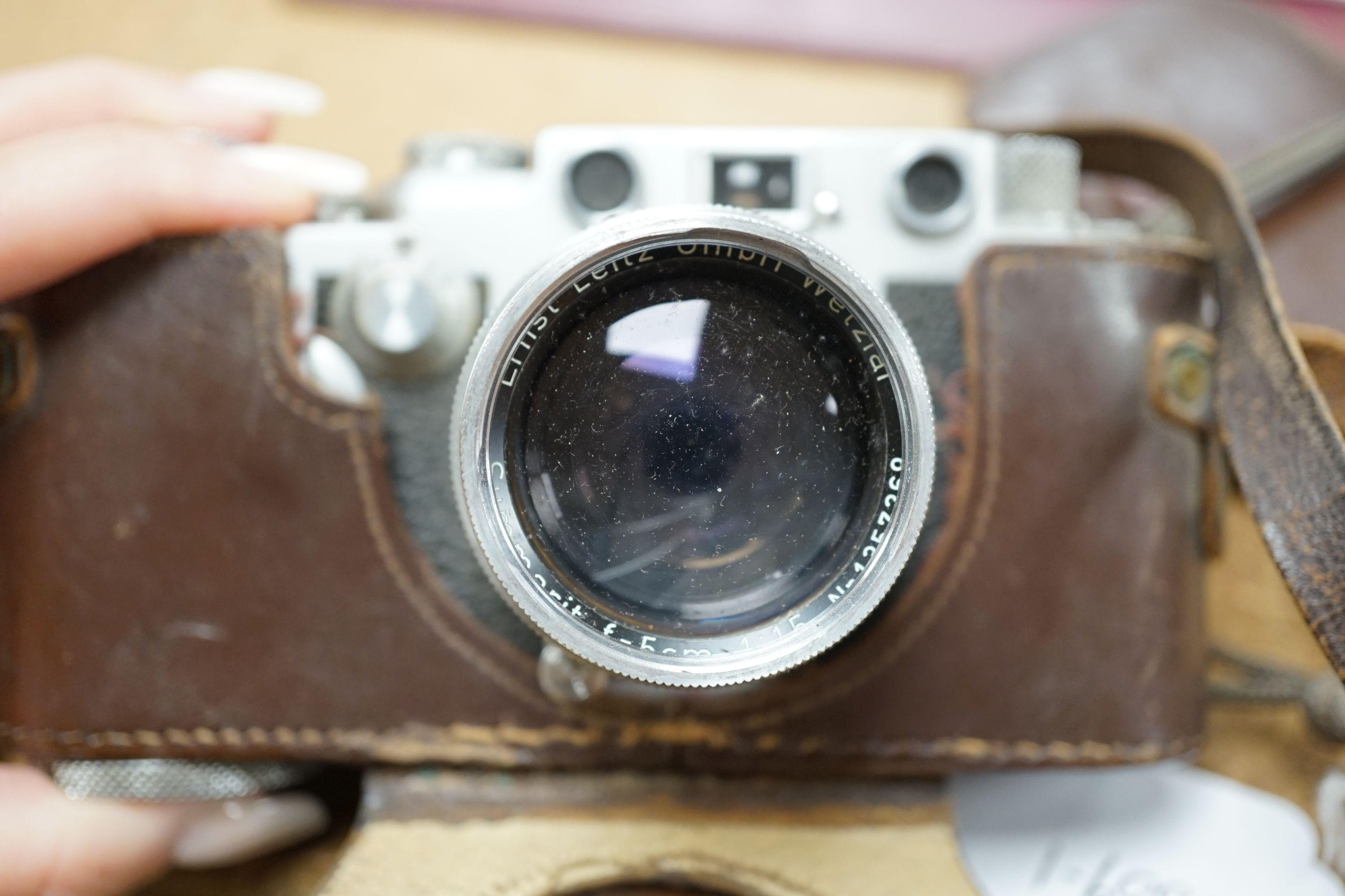A cased Leica III camera serial number 767261 with Ernst Leitz GmbH Wetzlar Summarit f=5cm 1:15 No.135729 lens and light exposure meter